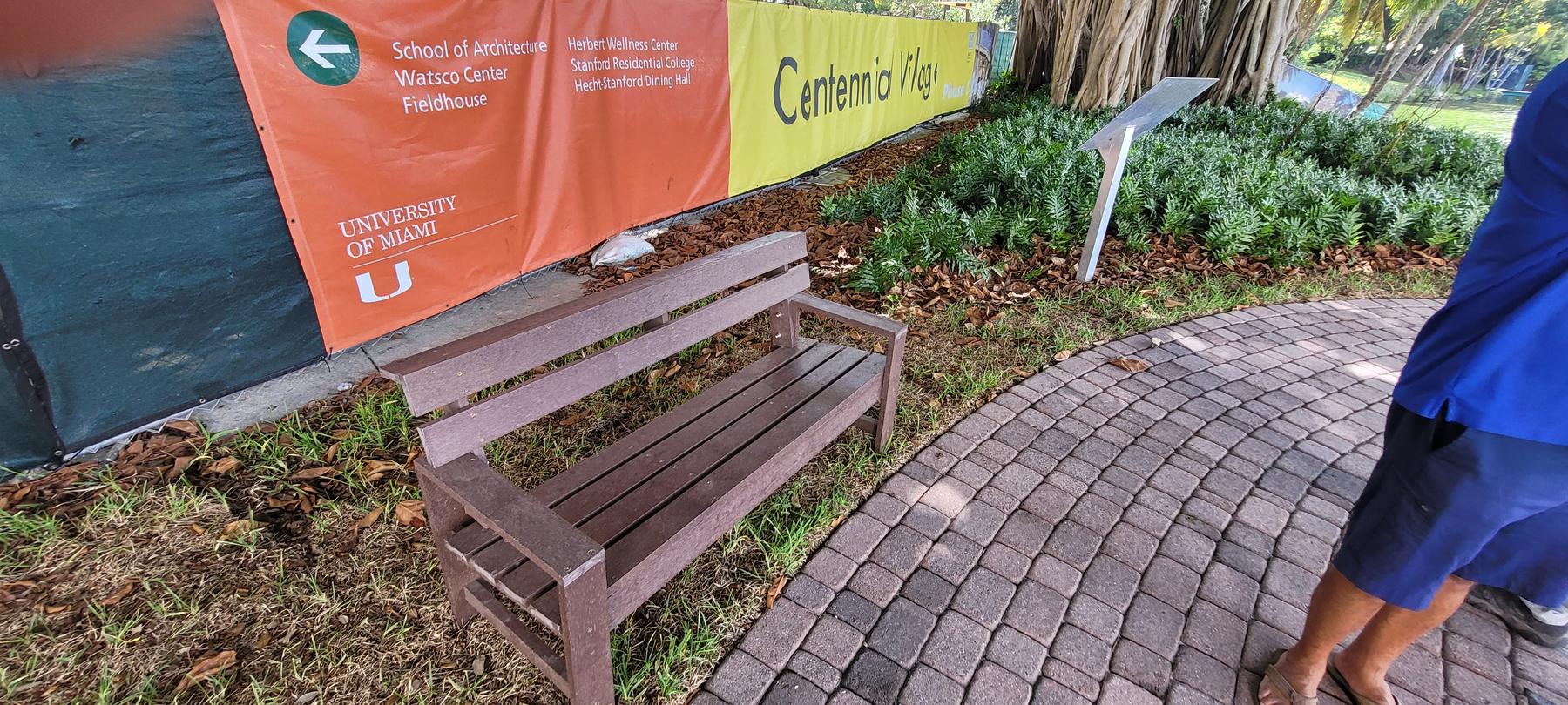 Everwood bench beside University of Miami Centennial Village banner
